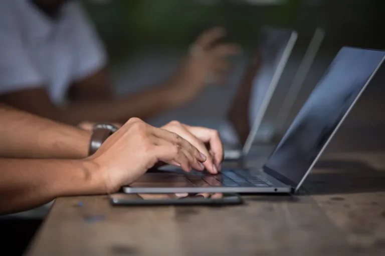Small business team reviewing an automated workflow dashboard on a laptop in an office