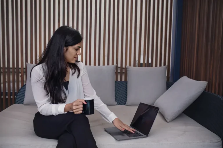 Person reading a welcome email on a laptop at a desk