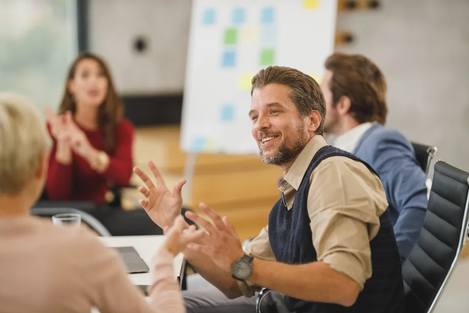 Small business team reviewing a documented workflow on a laptop in an office