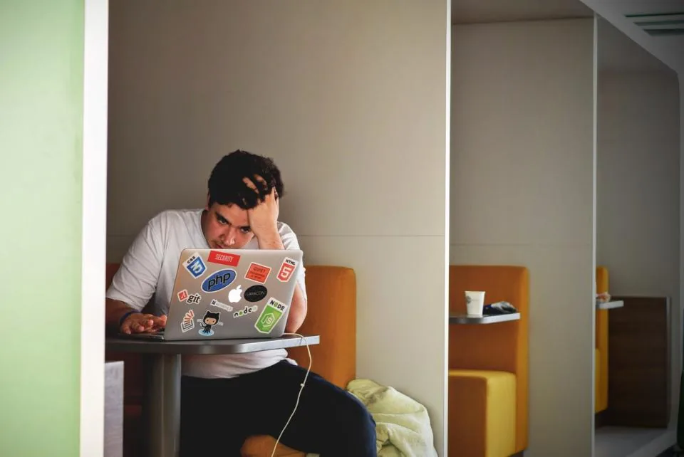 Business owner taking a break from a laptop to rest and reset during a busy workday