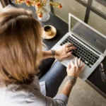Professional working on a side business on a laptop at home in the evening