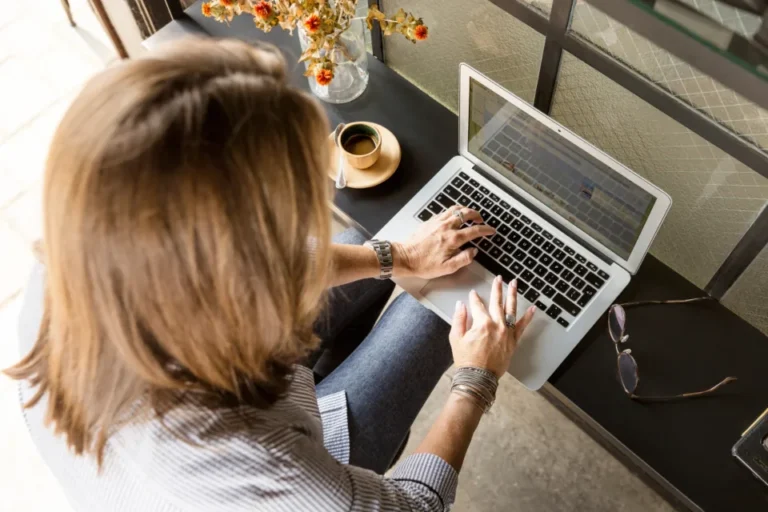Professional working on a side business on a laptop at home in the evening
