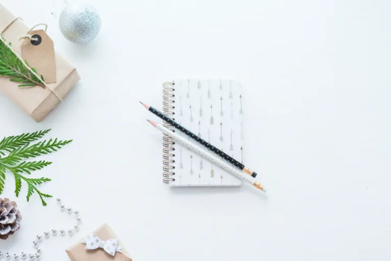 Open weekly planner notebook with a pen and coffee on a desk during a weekly review